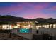 Modern home with infinity pool at sunset, mountain backdrop at 6516 E Meadowlark Ln, Paradise Valley, AZ 85253