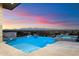 Infinity pool and spa with city and mountain views at sunset at 6516 E Meadowlark Ln, Paradise Valley, AZ 85253