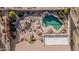 Aerial view of home showcasing a private pool, patio and desert landscaping at 7735 E Russell Cir, Mesa, AZ 85207