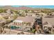 Aerial view of home showcasing a private pool, outdoor living space, and desert landscaping at 7735 E Russell Cir, Mesa, AZ 85207