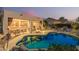 Stunning backyard with a sparkling pool, covered patio featuring ample seating, and beautiful desert landscaping at 7735 E Russell Cir, Mesa, AZ 85207