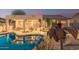 Beautiful backyard showcasing a sparkling pool, covered patio with outdoor furniture, and desert landscaping at 7735 E Russell Cir, Mesa, AZ 85207