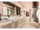 This bathroom showcases a double sink vanity and large mirror at 7735 E Russell Cir, Mesa, AZ 85207