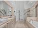 Primary bathroom featuring double sinks, and separate soaking tub and shower at 7735 E Russell Cir, Mesa, AZ 85207