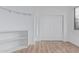 Clean, neutral bedroom with wood-look floors and a closet with sliding doors at 7735 E Russell Cir, Mesa, AZ 85207