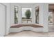 Breakfast nook with bay windows and built-in bench seating overlooking backyard at 7735 E Russell Cir, Mesa, AZ 85207