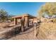 Charming community park featuring a covered gazebo with picnic tables, desert vegetation, and a pet waste station at 7735 E Russell Cir, Mesa, AZ 85207