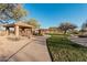 Well-maintained community park featuring a covered gazebo, picnic tables, and a walking path amidst lush green grass at 7735 E Russell Cir, Mesa, AZ 85207