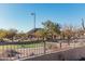 Scenic view of a community park with walking paths, gazebos, desert landscaping, and mountain views at 7735 E Russell Cir, Mesa, AZ 85207