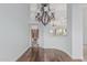 Bright dining area with wood floors, chandelier, and access to the kitchen at 7735 E Russell Cir, Mesa, AZ 85207