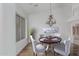 Formal dining room boasts modern chandelier, wood floors and large window with bright natural light at 7735 E Russell Cir, Mesa, AZ 85207