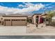 Well-maintained home exterior with a three-car garage, desert landscaping, and inviting front entry at 7735 E Russell Cir, Mesa, AZ 85207