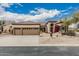 Beautiful single-story home with a three-car garage, desert landscaping, and a tile roof at 7735 E Russell Cir, Mesa, AZ 85207