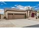 Charming home with a three-car garage, tile roof, and desert-style landscaping with pops of color at 7735 E Russell Cir, Mesa, AZ 85207