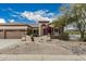 Beautiful home featuring mature desert landscaping, decorative rock and plantings, and a tile roof at 7735 E Russell Cir, Mesa, AZ 85207