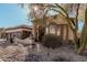 Charming home featuring desert landscaping, an arched entryway, and a tile roof at 7735 E Russell Cir, Mesa, AZ 85207