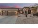 Charming home featuring a two-car garage, desert landscaping, and a tile roof at 7735 E Russell Cir, Mesa, AZ 85207