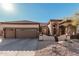 Beautiful home featuring desert landscaping, a three-car garage, and an arched entryway at 7735 E Russell Cir, Mesa, AZ 85207
