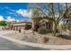 Attractive home featuring mature desert landscaping, decorative rock and plantings, and a tile roof at 7735 E Russell Cir, Mesa, AZ 85207