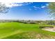 This golf course features a well-maintained green and distant mountain views, creating a serene and enjoyable playing experience at 7735 E Russell Cir, Mesa, AZ 85207