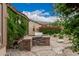 Outdoor grill area surrounded by lush greenery, stone accents, and serene backyard ambiance at 7735 E Russell Cir, Mesa, AZ 85207