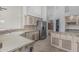 Large kitchen with stainless steel refrigerator, breakfast bar, and decorative cabinetry at 7735 E Russell Cir, Mesa, AZ 85207