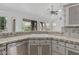 Charming kitchen featuring light cabinets, neutral countertops, and a view to the backyard at 7735 E Russell Cir, Mesa, AZ 85207