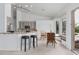 Eat-in kitchen with light countertops, bar seating, and bright breakfast nook with bay windows at 7735 E Russell Cir, Mesa, AZ 85207