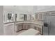 Open-concept kitchen with breakfast bar, stainless steel appliances, and views of backyard at 7735 E Russell Cir, Mesa, AZ 85207