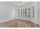 Bright room featuring wood floors, white walls, and windows with shutters for natural light and privacy at 7735 E Russell Cir, Mesa, AZ 85207