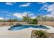 Backyard featuring a kidney-shaped pool, desert landscaping, and relaxing outdoor ambiance at 7735 E Russell Cir, Mesa, AZ 85207