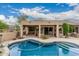 Backyard showcasing a beautiful pool, covered patio, and seamless indoor-outdoor living space at 7735 E Russell Cir, Mesa, AZ 85207