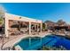 Inviting pool with a tranquil waterfall feature, covered patio and desert landscaping create a relaxing oasis at 7735 E Russell Cir, Mesa, AZ 85207