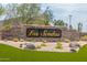The Las Sendas community entrance sign features attractive stone work and manicured landscaping, creating a welcoming atmosphere at 7735 E Russell Cir, Mesa, AZ 85207