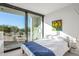 Bedroom with blue and white bedding, and large window showcasing desert view at 7915 E Primrose Path, Carefree, AZ 85377