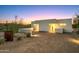 Modern home exterior at sunset with a gravel driveway at 7915 E Primrose Path, Carefree, AZ 85377
