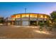 Circular home with desert landscaping, at dusk at 7915 E Primrose Path, Carefree, AZ 85377