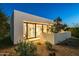Modern home exterior with desert landscaping at dusk at 7915 E Primrose Path, Carefree, AZ 85377