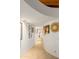 Curved hallway with artwork and tile floors at 7915 E Primrose Path, Carefree, AZ 85377