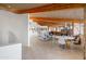 Mid-century modern living room with a stone fireplace and vaulted wood ceilings at 7915 E Primrose Path, Carefree, AZ 85377