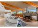Open living space featuring a circular fireplace and expansive windows at 7915 E Primrose Path, Carefree, AZ 85377