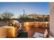 Deck with built-in grill and seating area at 7915 E Primrose Path, Carefree, AZ 85377