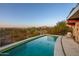 Luxury pool with mountain views and desert landscape at 7915 E Primrose Path, Carefree, AZ 85377