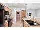 Kitchen with black appliances and a farmhouse style door at 830 E Tortoise Trl, San Tan Valley, AZ 85143