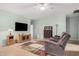 Living room with two recliners, TV, and wooden cabinet at 830 E Tortoise Trl, San Tan Valley, AZ 85143