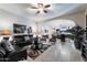 Open living room with tile floors, a ceiling fan, and access to the kitchen at 8434 E Kael St, Mesa, AZ 85207