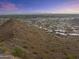 Expansive aerial view of a desert landscape featuring distant mountain views under a colorful sky at sunset at 9410 N 4Th Ave, Phoenix, AZ 85021