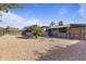 Wide open backyard featuring rock ground cover, mature trees, a privacy fence and seating at 9410 N 4Th Ave, Phoenix, AZ 85021
