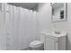 Clean bathroom with a shower-tub combo and white fixtures and grey walls at 9410 N 4Th Ave, Phoenix, AZ 85021