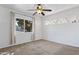 Sunny bedroom with carpeted floors, ceiling fan, and large window; perfect for relaxation at 9410 N 4Th Ave, Phoenix, AZ 85021